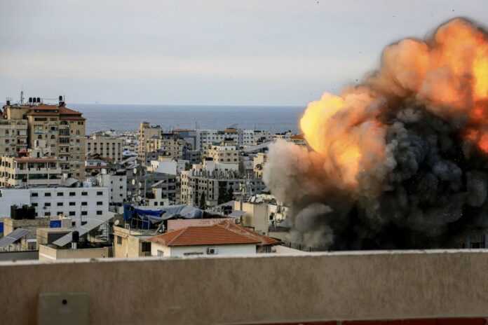 Smoke and flames billow after Israeli forces hit a high-rise tower in Gaza City